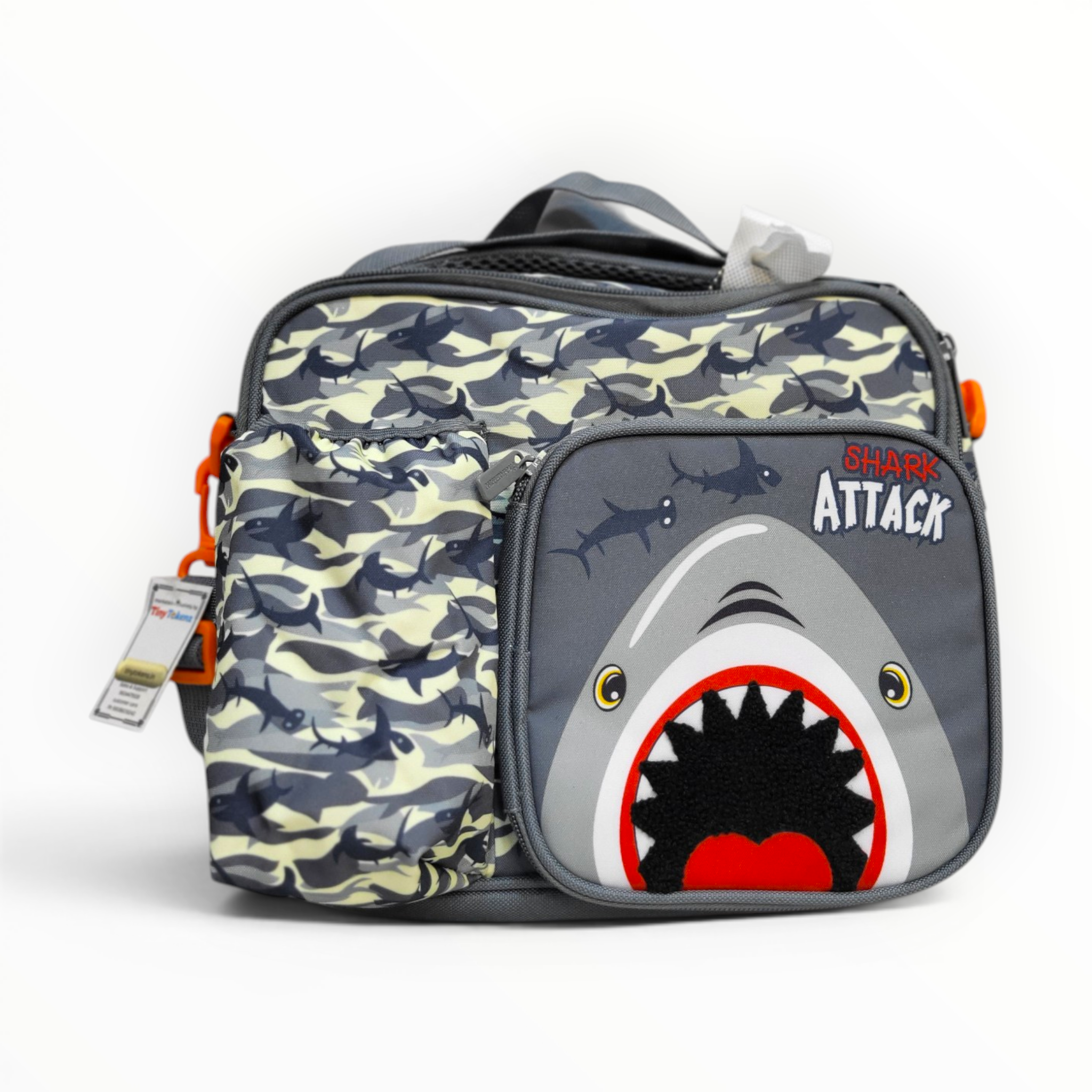 Front view of a grey and yellow shark camo patterned kids insulated lunch bag featuring a prominent "Shark Attack" shark graphic front zippered pocket and a built-in side water bottle holder against a white background.