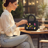 Tiny Tokens black EVA kids handbag with round handle and fun charms like a tiger, flower, star, and soccer ball.