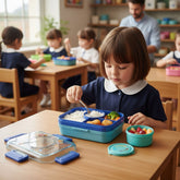 Tiny Tokens blue dump truck lunch box with steel tray, spoon, and separate container. Features secure latches and a fun transparent lid.