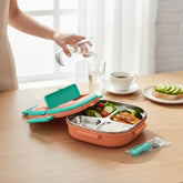 Tiny Tokens kids 3-section stainless steel lunch box in terracotta orange with teal accents, includes spoon and fork.