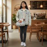 Tiny Tokens quilted cotton duffle bag with blue, green, and orange animal print. Features striped strap and zip closure. Ideal for kids aged 3-10.