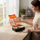 Tiny Tokens kids 3-section stainless steel bento lunch box with orange lid and space theme. Spill-proof and includes cutlery.