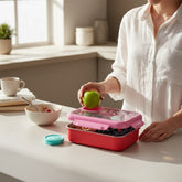 Tiny Tokens pink and red stainless steel bento lunch box for kids with teal cutlery and sauce cup.