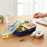 Tiny Tokens blue cartoon steel lunch box with astronaut design, two compartments, mini bowl, and spoon.