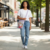 Tiny Tokens lavender 3D cartoon tuition bag with Hello Kitty on a strawberry, fruits, and clouds. Features multiple pockets.