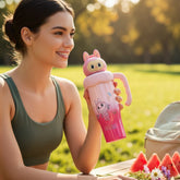 Tiny Tokens pink ombre steel tumbler with 3D bunny monster lid, handle, and straw. Features cartoon character and tropical print.