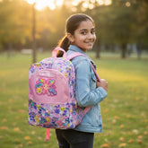 Tiny Tokens pink backpack with all-over print of smile emojis, bunnies, flowers, and BFFs. Features a glossy front pocket with a 3D flower emoji badge.