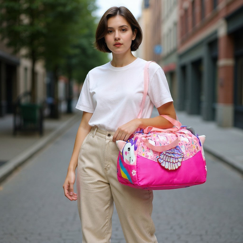 Tiny Tokens pink unicorn duffle bag with 3D wings, glitter horn, and all-over unicorn print. Ideal for girls' travel and sports.