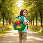 Tiny Tokens blue and yellow striped backpack with a red 3D airplane applique and green trim. Features hot air balloons and small planes.