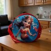 Tiny Tokens red round crossbody bag with a 3D cartoon mermaid and "Sea Ya!" graphic. Features adjustable strap.