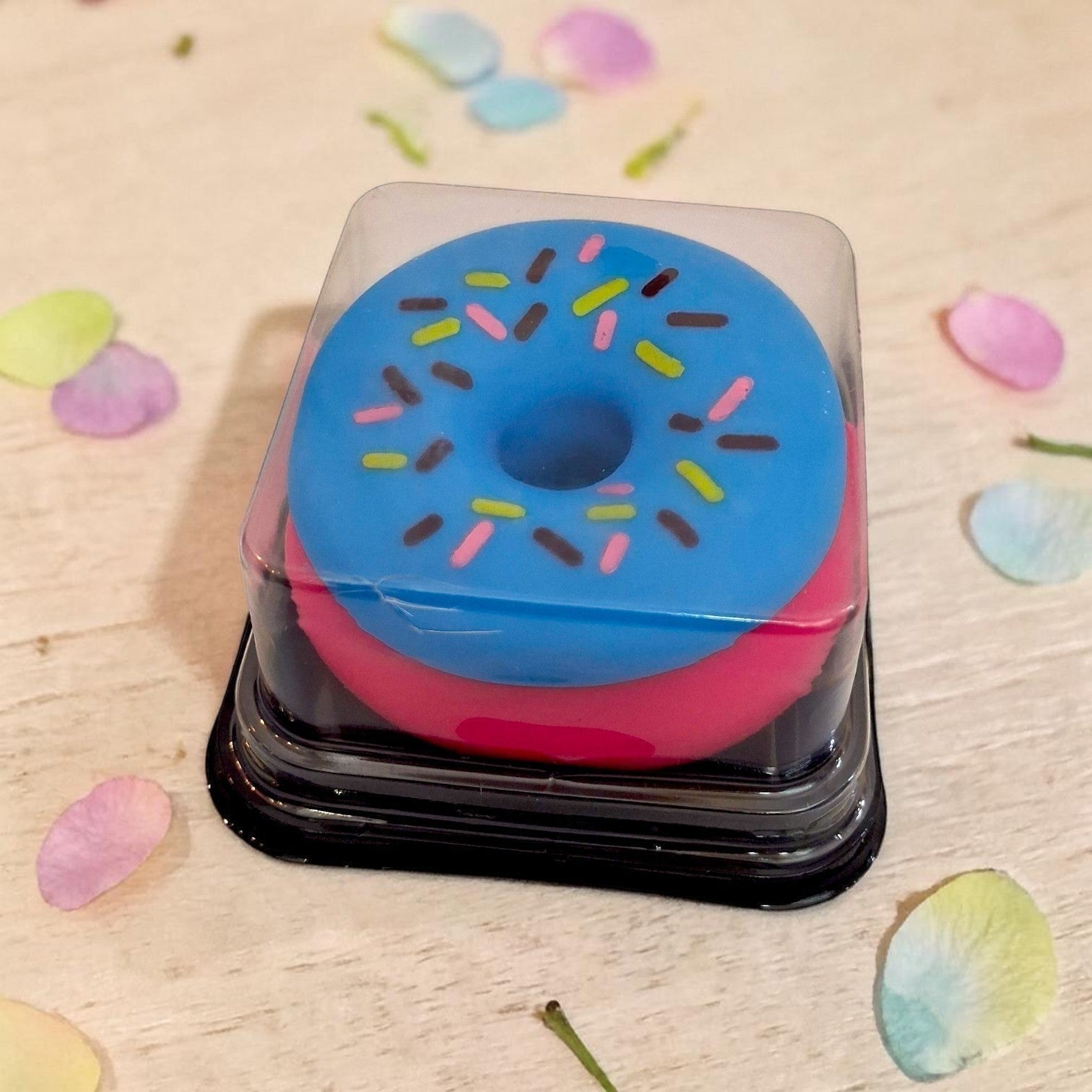Tiny Tokens blue and pink donut squishy toy with sprinkles, made of soft silicone for stress relief.
