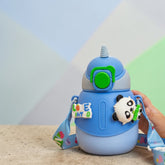 Tiny Tokens blue insulated steel kids bottle with unicorn horn lid, panda charm, flip straw, and printed strap.