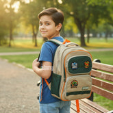 Tiny Tokens khaki, green, and orange dinosaur backpack for boys with embroidered dino badges and multiple compartments.