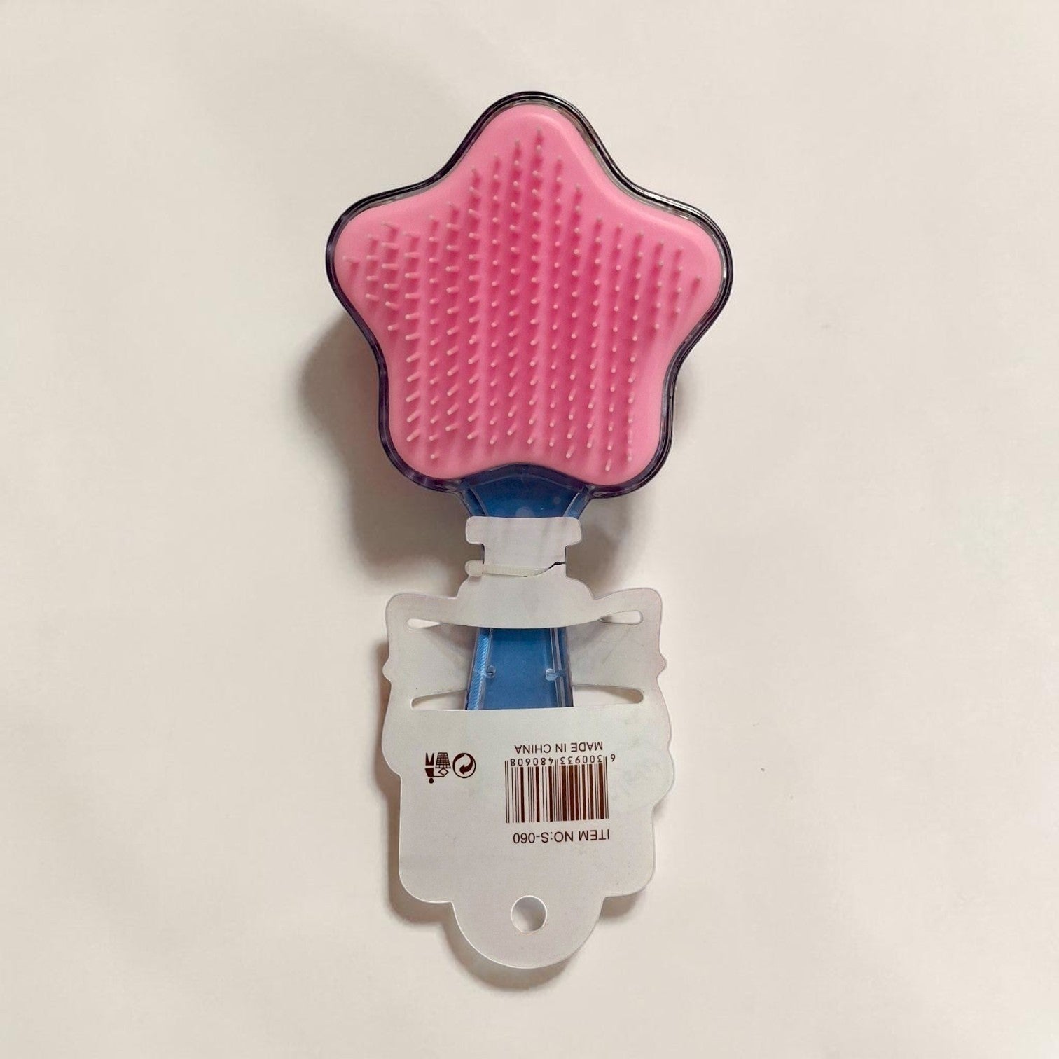 Tiny Tokens star-shaped pink glitter hair comb with blue handle for kids. Features soft bristles and fun mermaid artwork.
