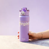 Tiny Tokens lavender steel insulated sports bottle with flip lid and motivational 'Begin!' band. Ideal for school and daily use.