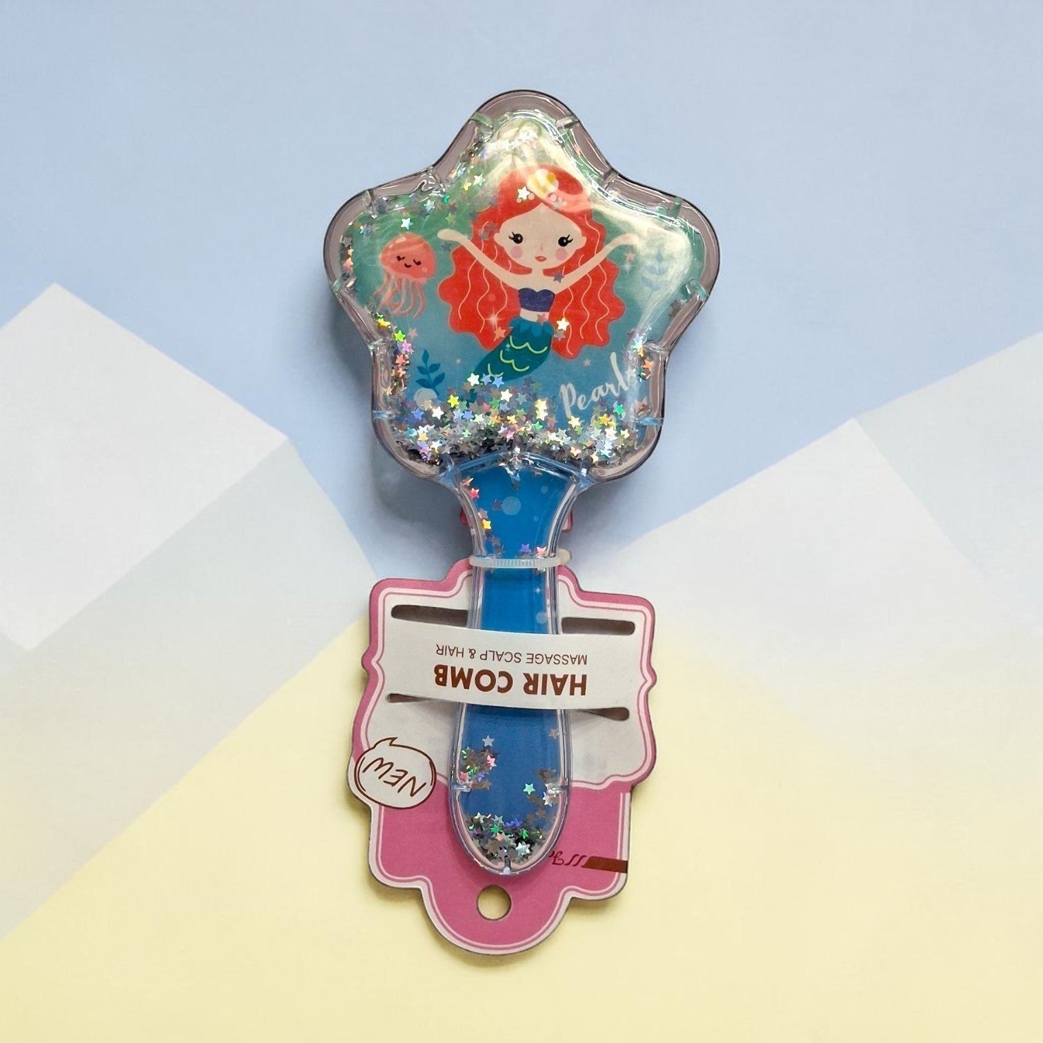 Tiny Tokens blue mermaid glitter hair comb with star-shaped head and soft bristles for scalp massage.