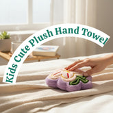 Tiny Tokens purple and pink plush flower hand towel with green leaves and a hanging loop. Features embroidered details.