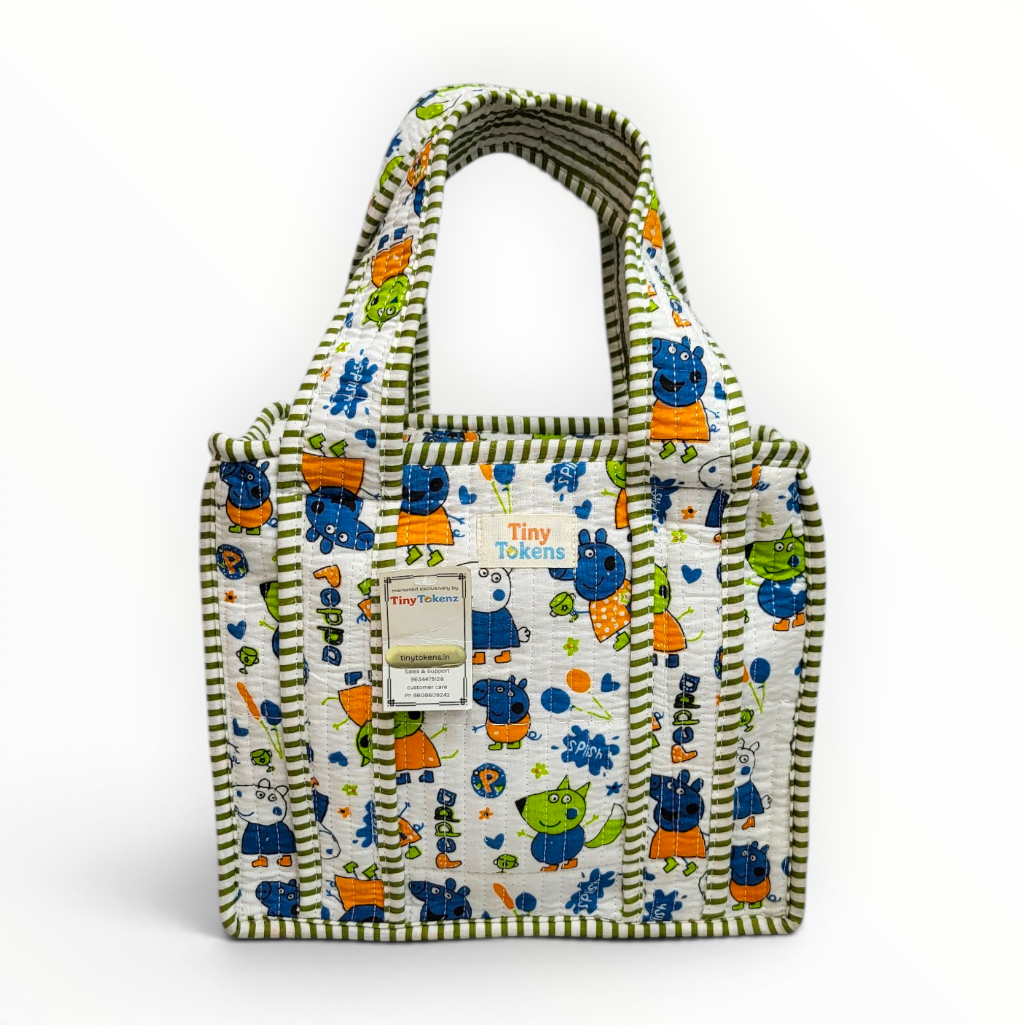 Back view of the quilted cotton lunch tote showcasing the centrally stitched "Tiny Tokenz" brand name label and paper product tag.
