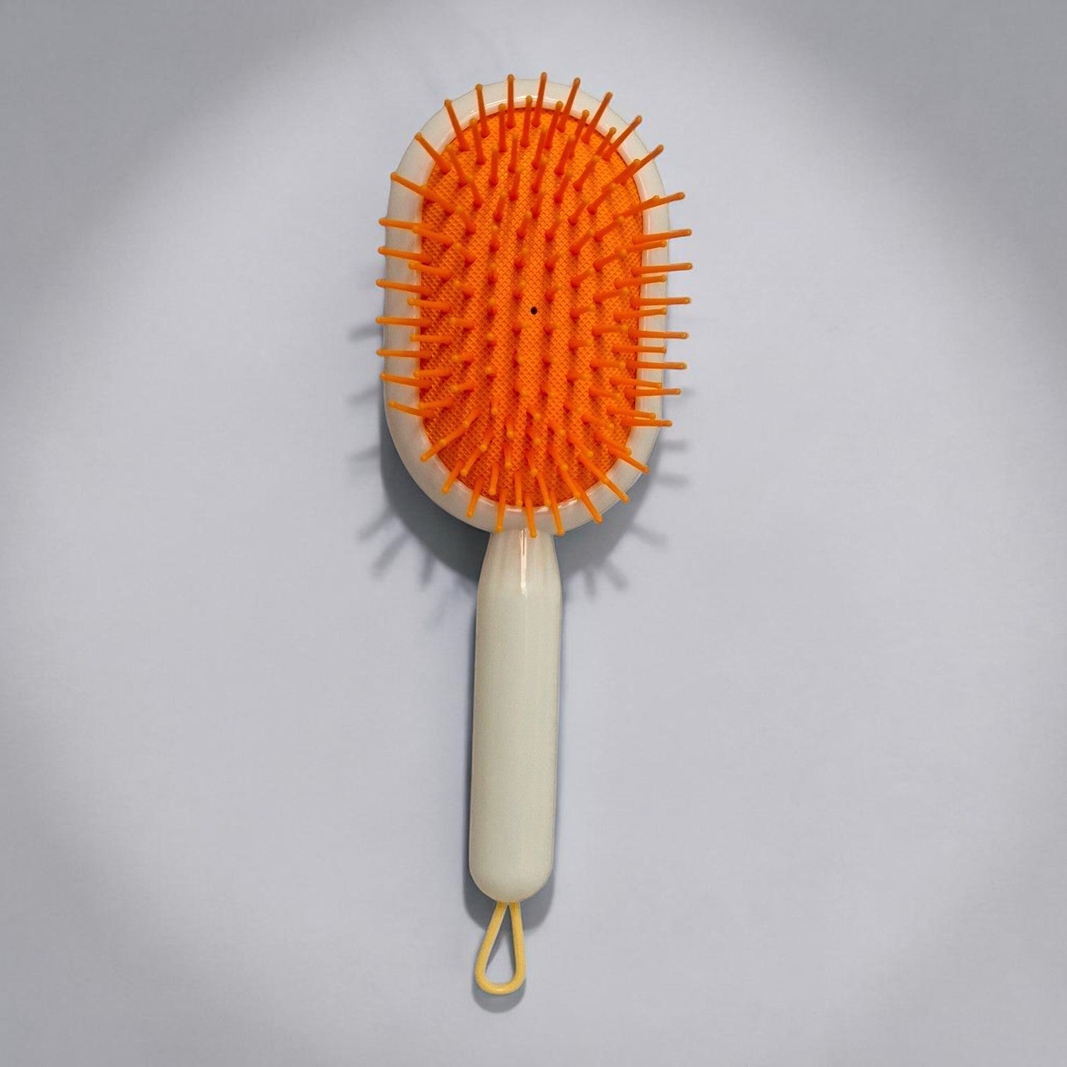 Tiny Tokens orange and white kids cartoon cushion hair brush with soft flexible bristles and hanging loop.