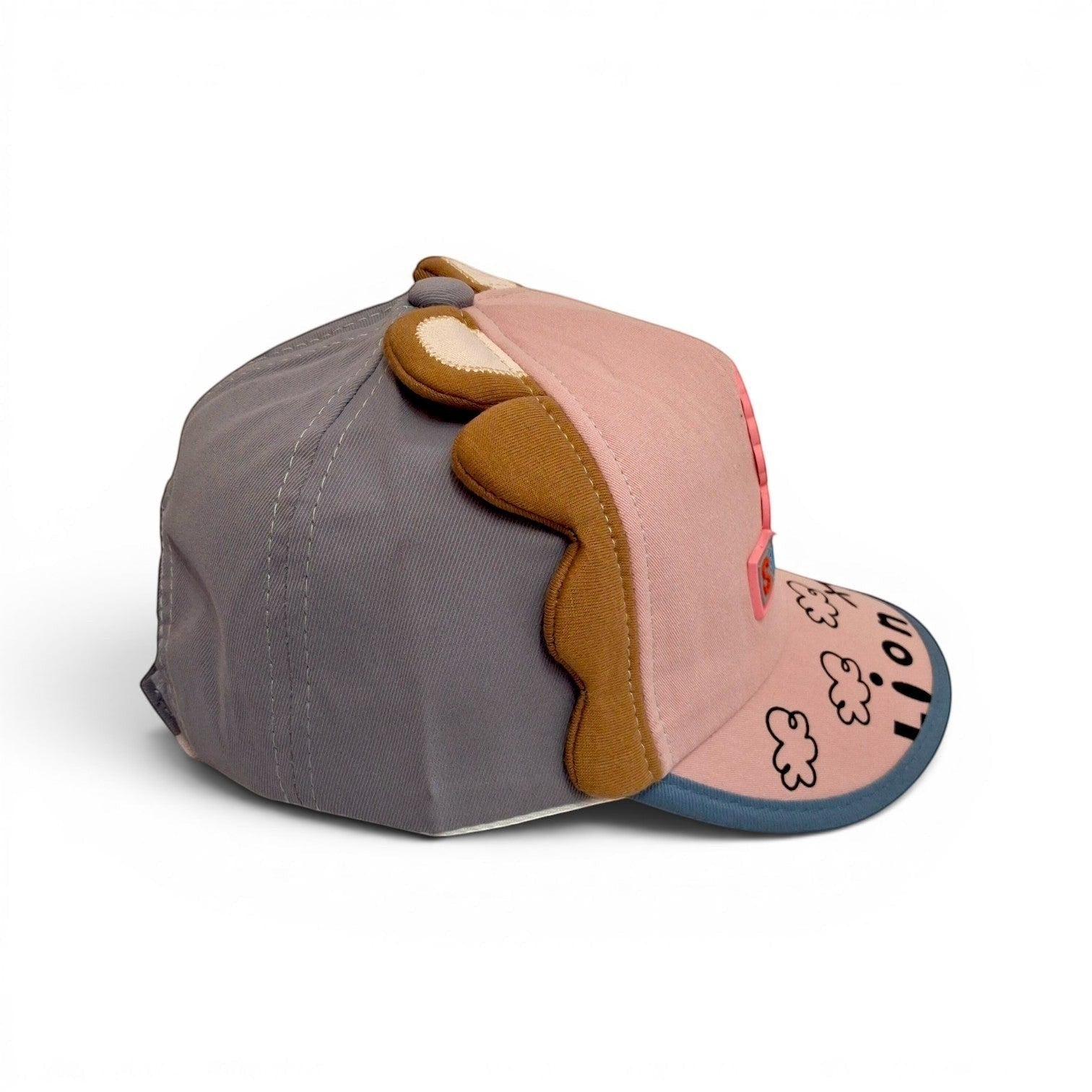 Tiny Tokens pink and grey cotton baseball cap with 3D lion ears and mane detail. Curved brim with cloud pattern.