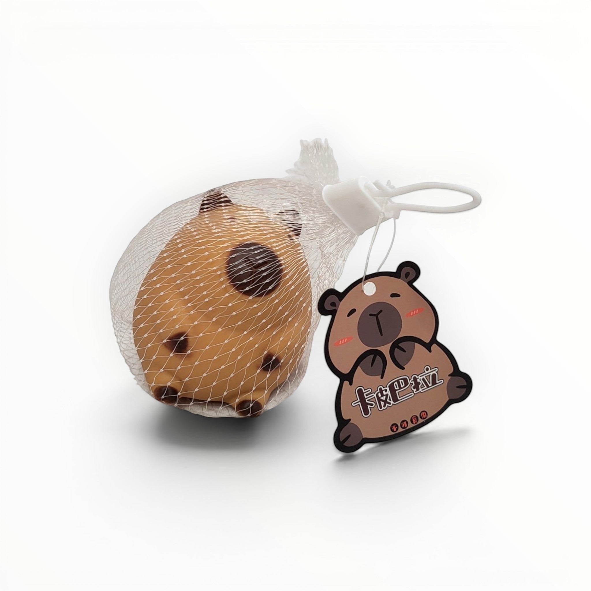 Tiny Tokens brown squishy capybara stress relief toy in mesh bag with cute tag.