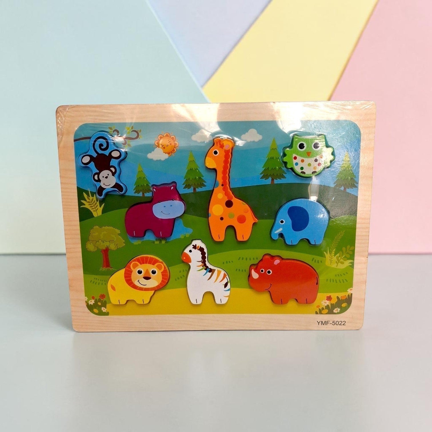 Tiny Tokens jungle animals wooden peg puzzle board with a monkey, hippo, giraffe, owl, lion, zebra, elephant, and rhino.