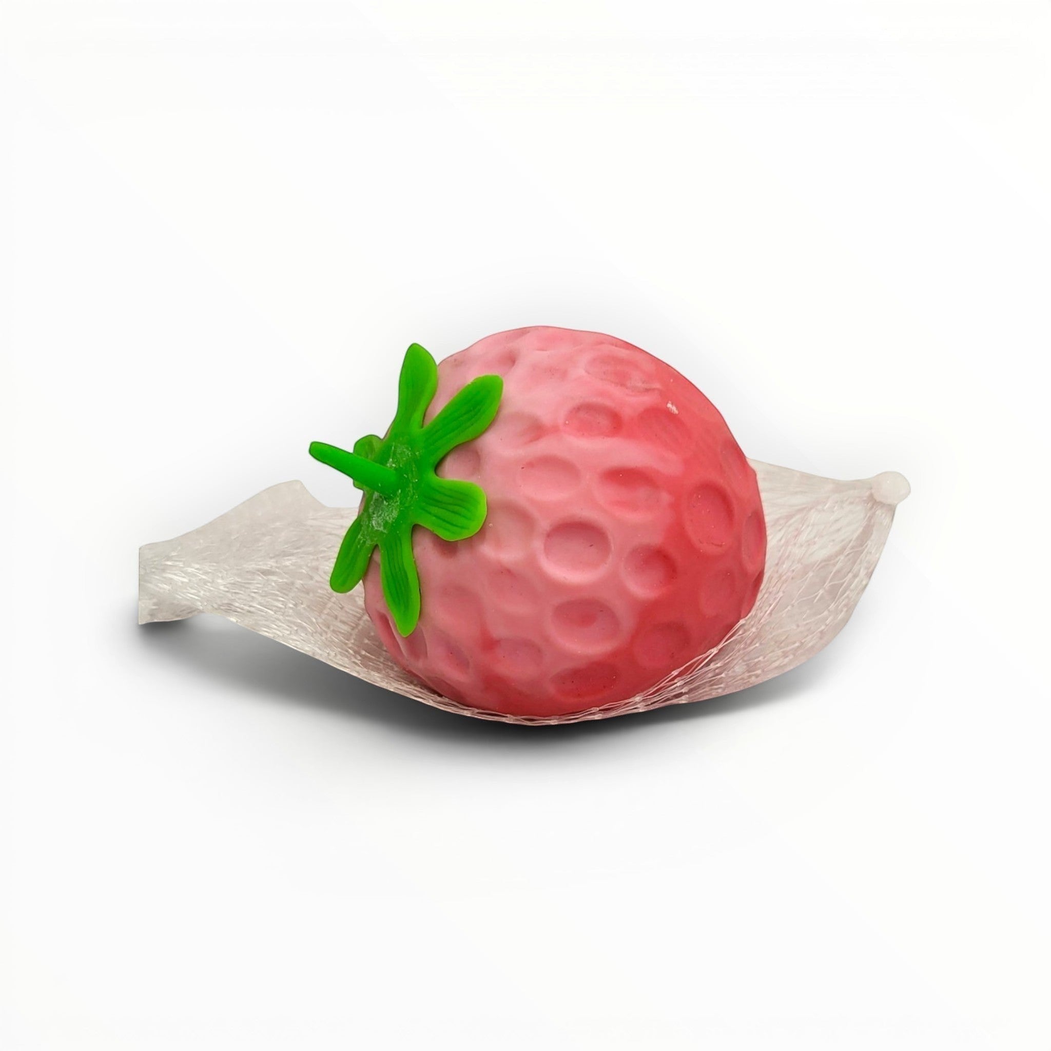 Tiny Tokens pink strawberry stress relief toy with green stem, made of soft rubber with dimpled texture.