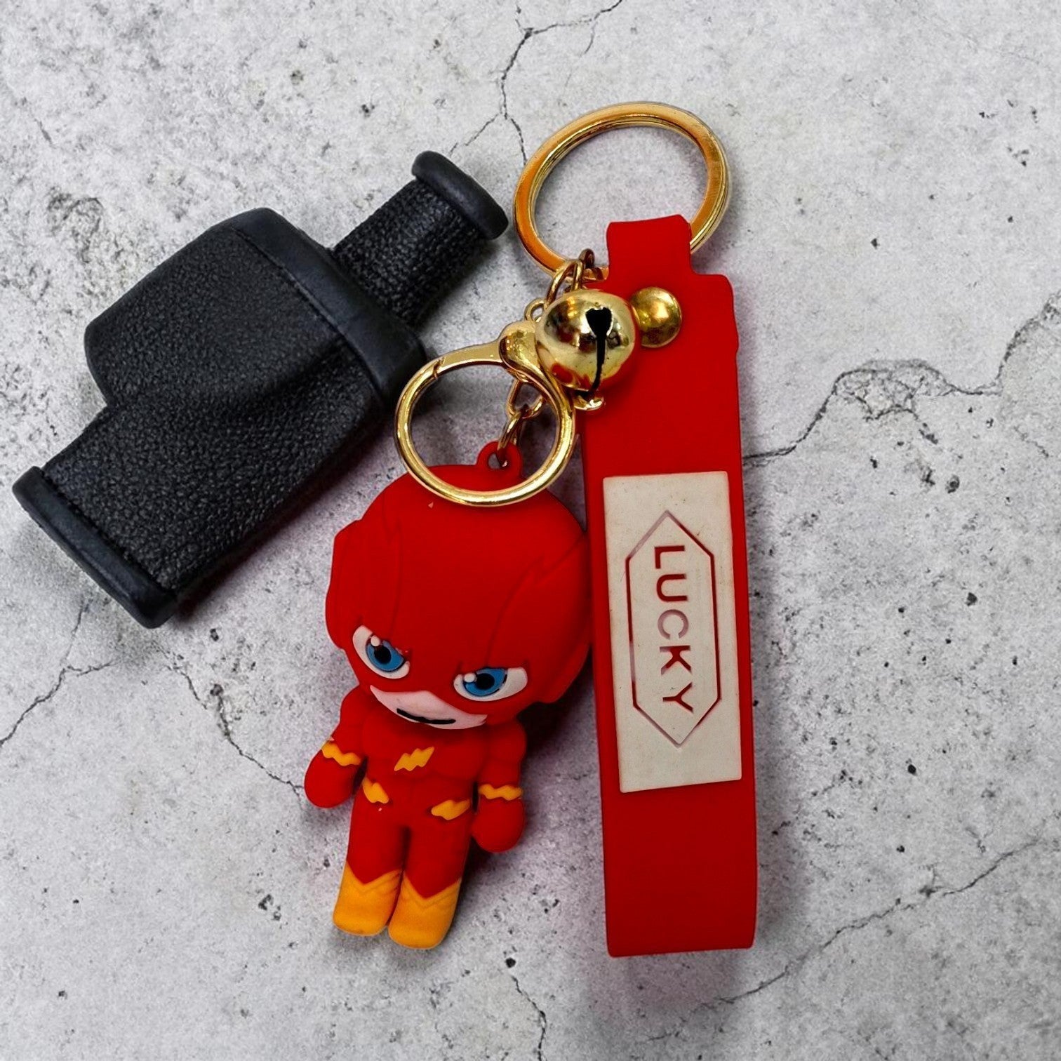 Tiny Tokens red 3D rubber Flash superhero keychain with blue eyes and yellow accents, attached to a red strap with 'LUCKY' text.
