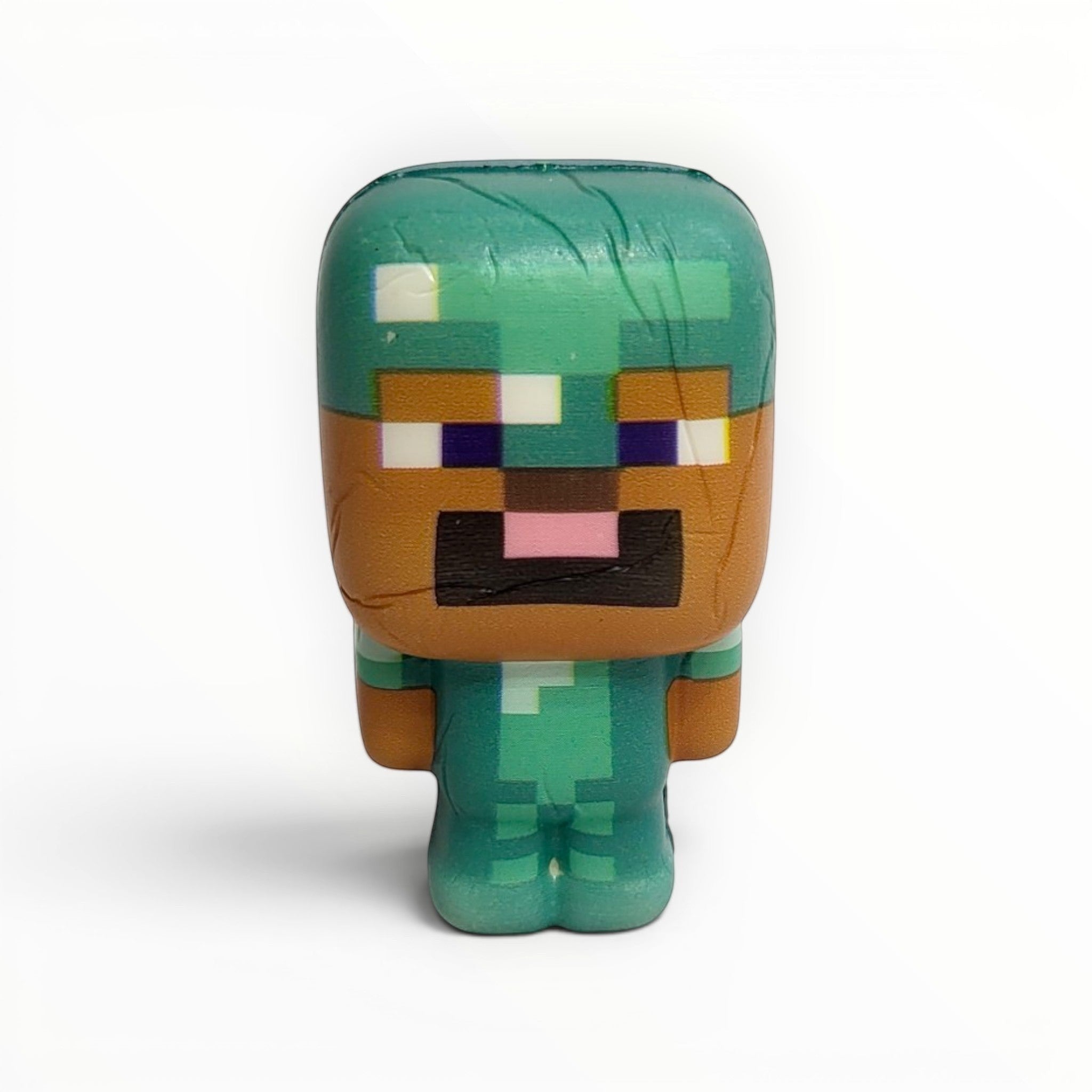 Tiny Tokens Minecraft-style pixel character squeeze toy in teal and brown, made of soft rubber for stress relief and play.