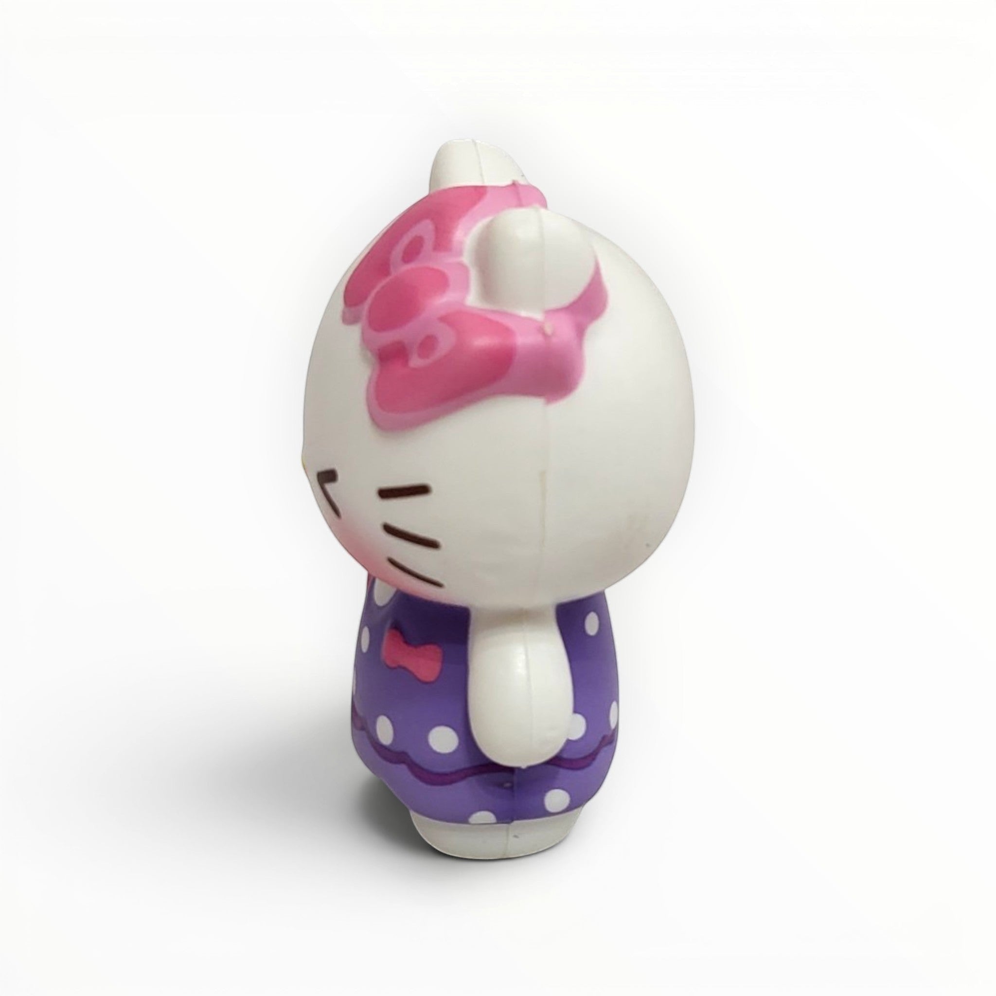 Tiny Tokens white cat squishy toy with pink bow and purple polka dot dress, soft rubber stress relief figure for girls.