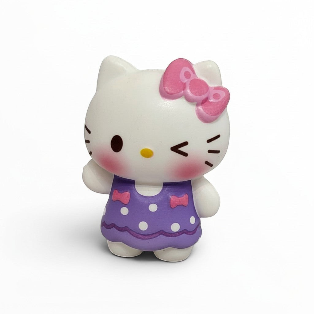 Tiny Tokens white cat squishy toy with pink bow and purple polka dot dress, winking and blushing.