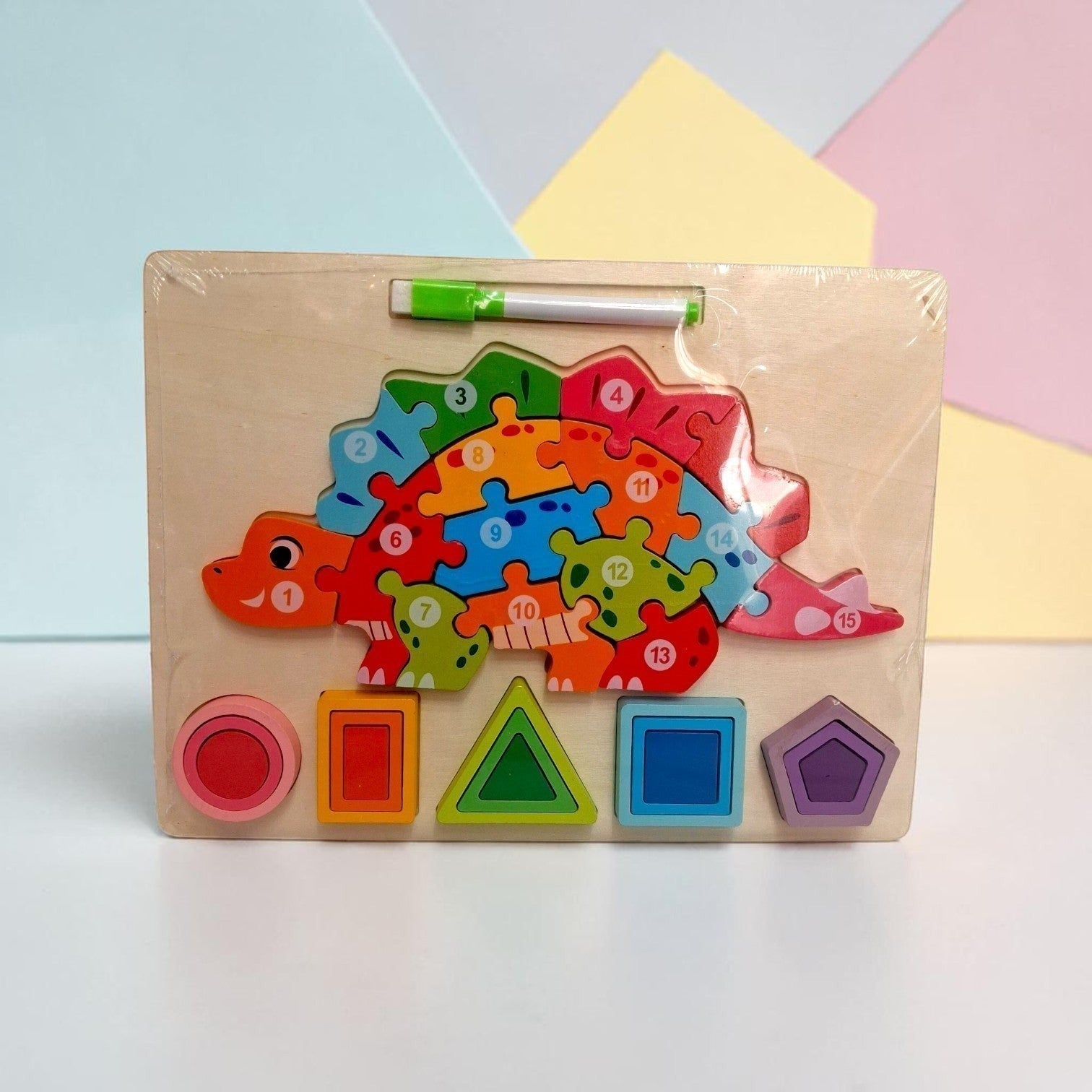 Tiny Tokens wooden dinosaur puzzle board with numbered pieces and shape sorter. Includes erasable marker.