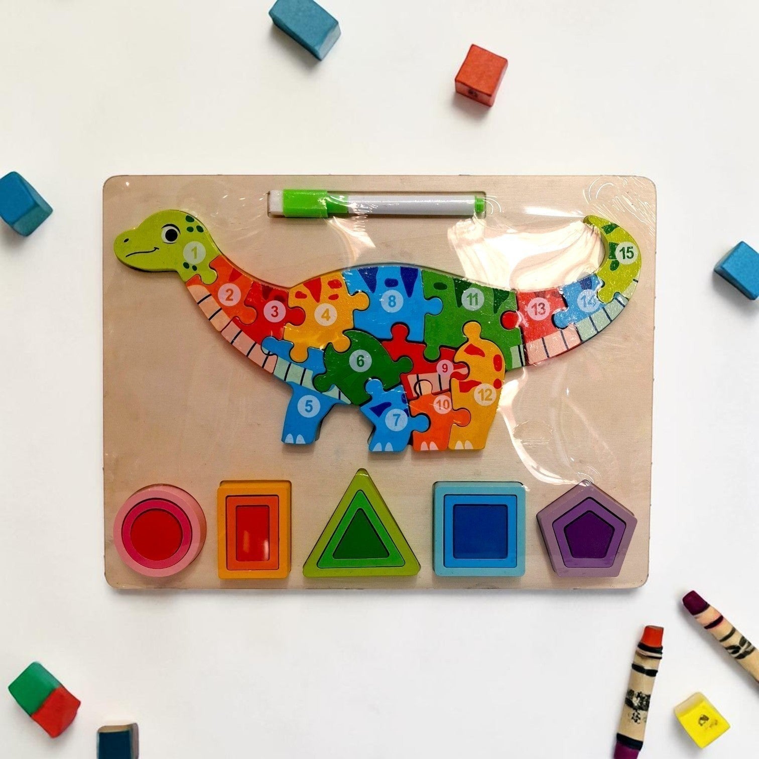 Tiny Tokens wooden dinosaur puzzle board with numbered pieces and shape sorter. Includes erasable marker for scribble back.