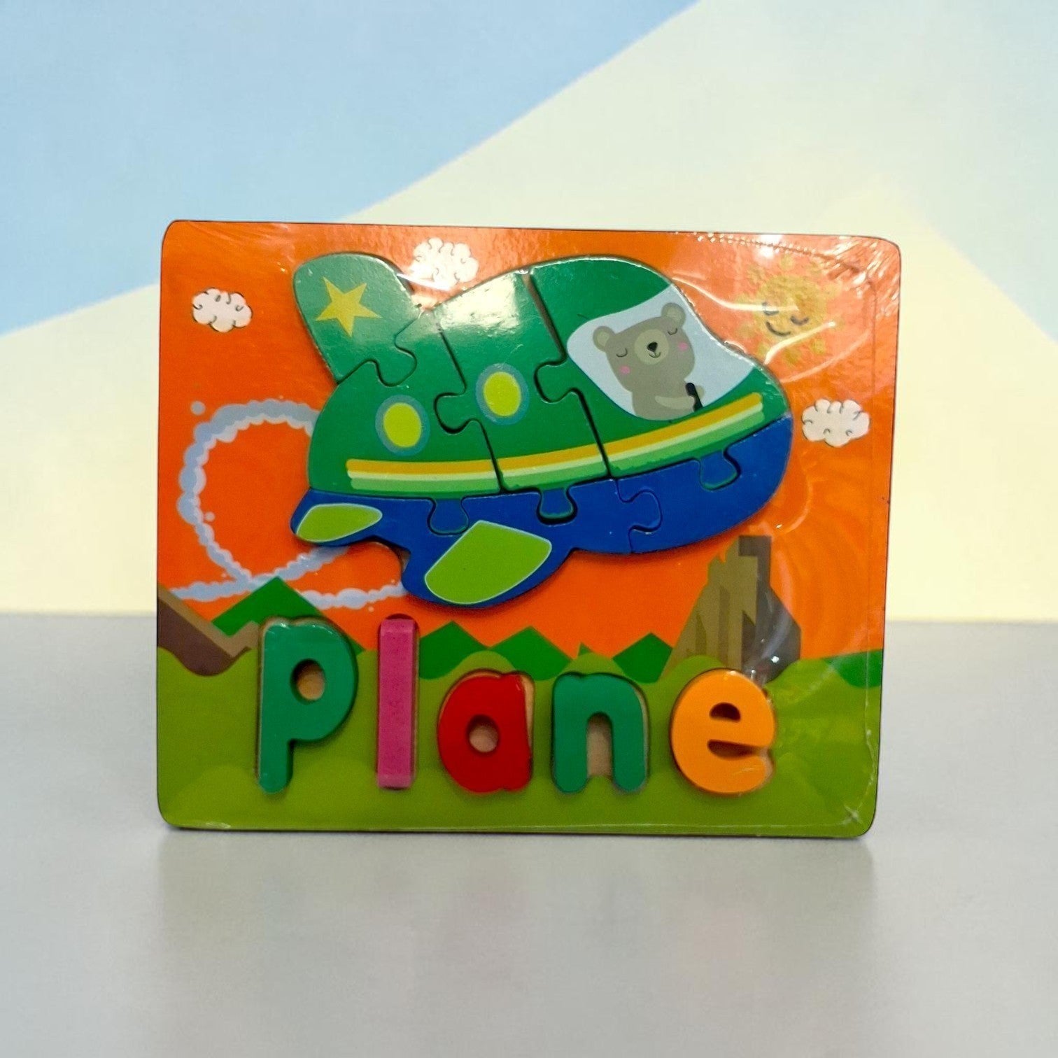 Tiny Tokens wooden plane puzzle board with chunky 3D letters for early literacy learning.