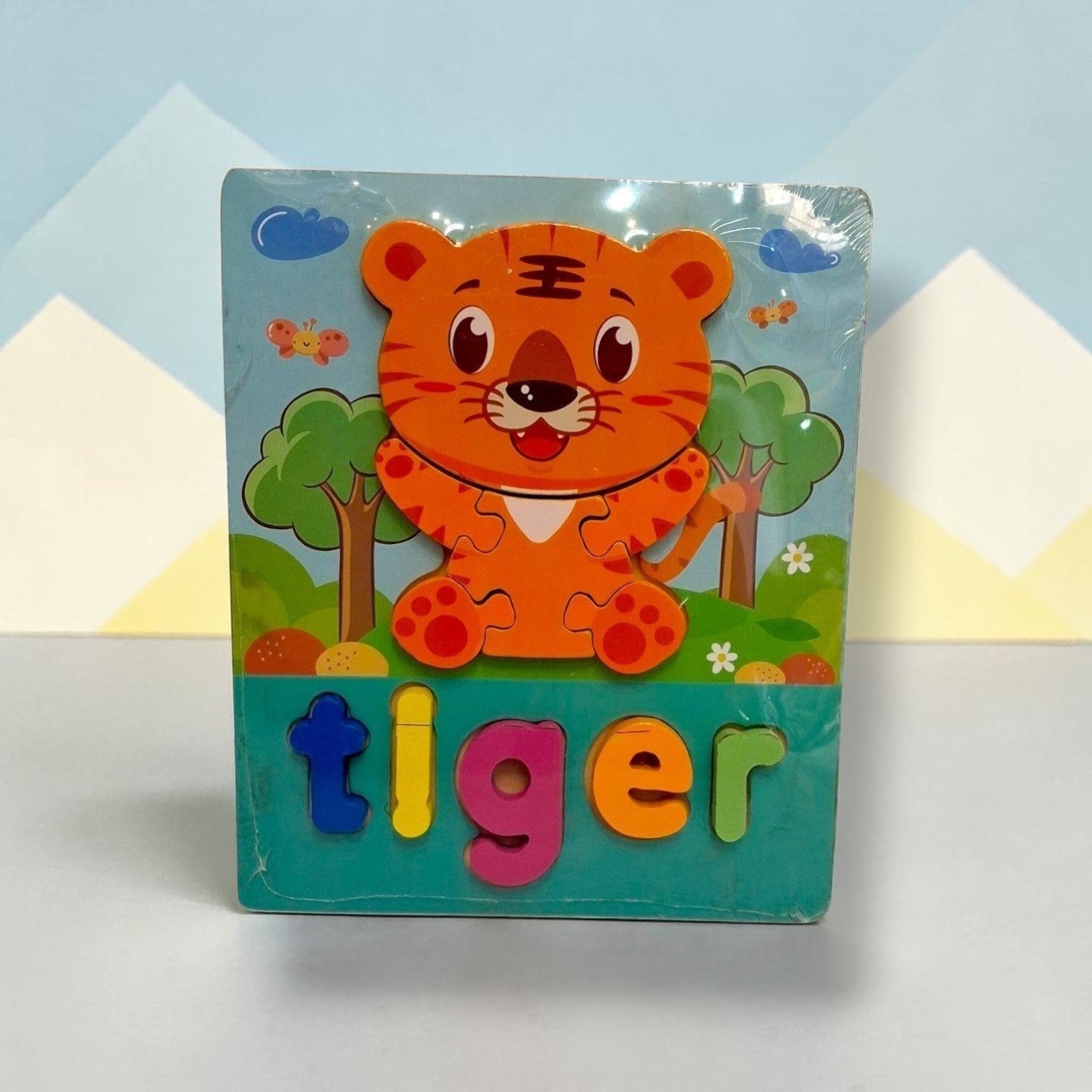 Tiny Tokens wooden tiger puzzle board with chunky, colourful letters spelling 'tiger'. Features a cute tiger illustration and jungle background.