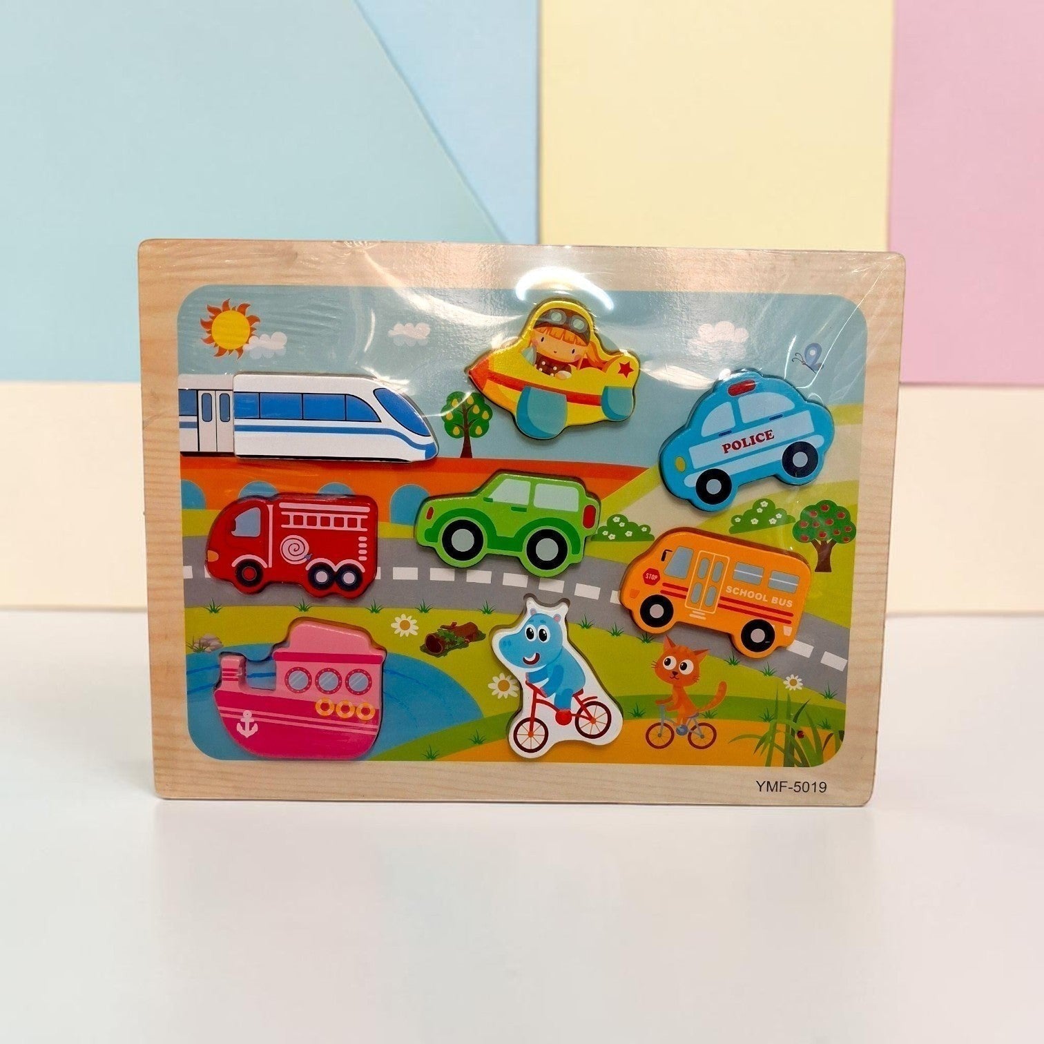 Tiny Tokens transport-themed wooden peg puzzle with train, car, police car, fire truck, school bus, and boat.