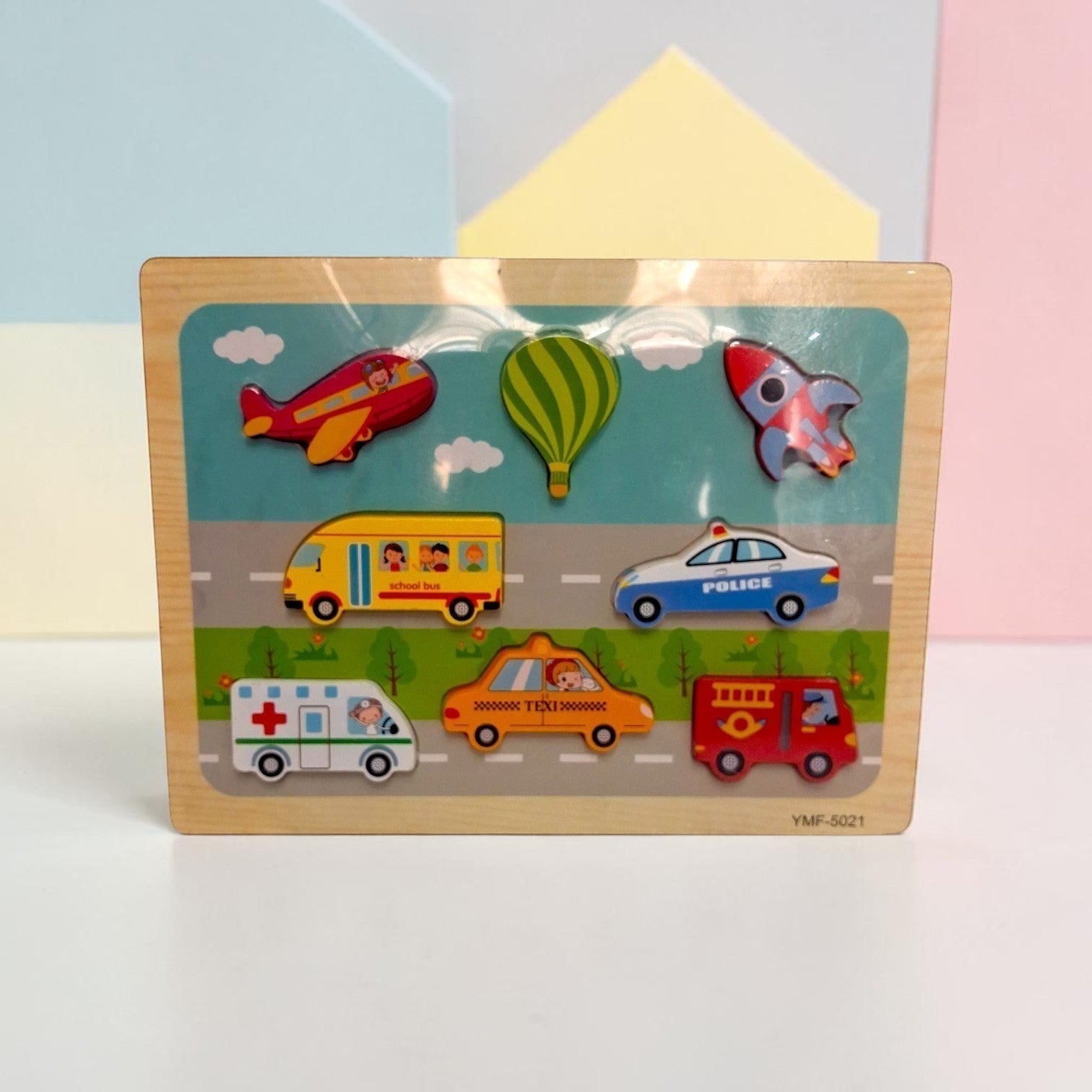 Tiny Tokens transport-themed wooden peg puzzle with airplane, hot air balloon, rocket, school bus, police car, ambulance, taxi, and fire truck.