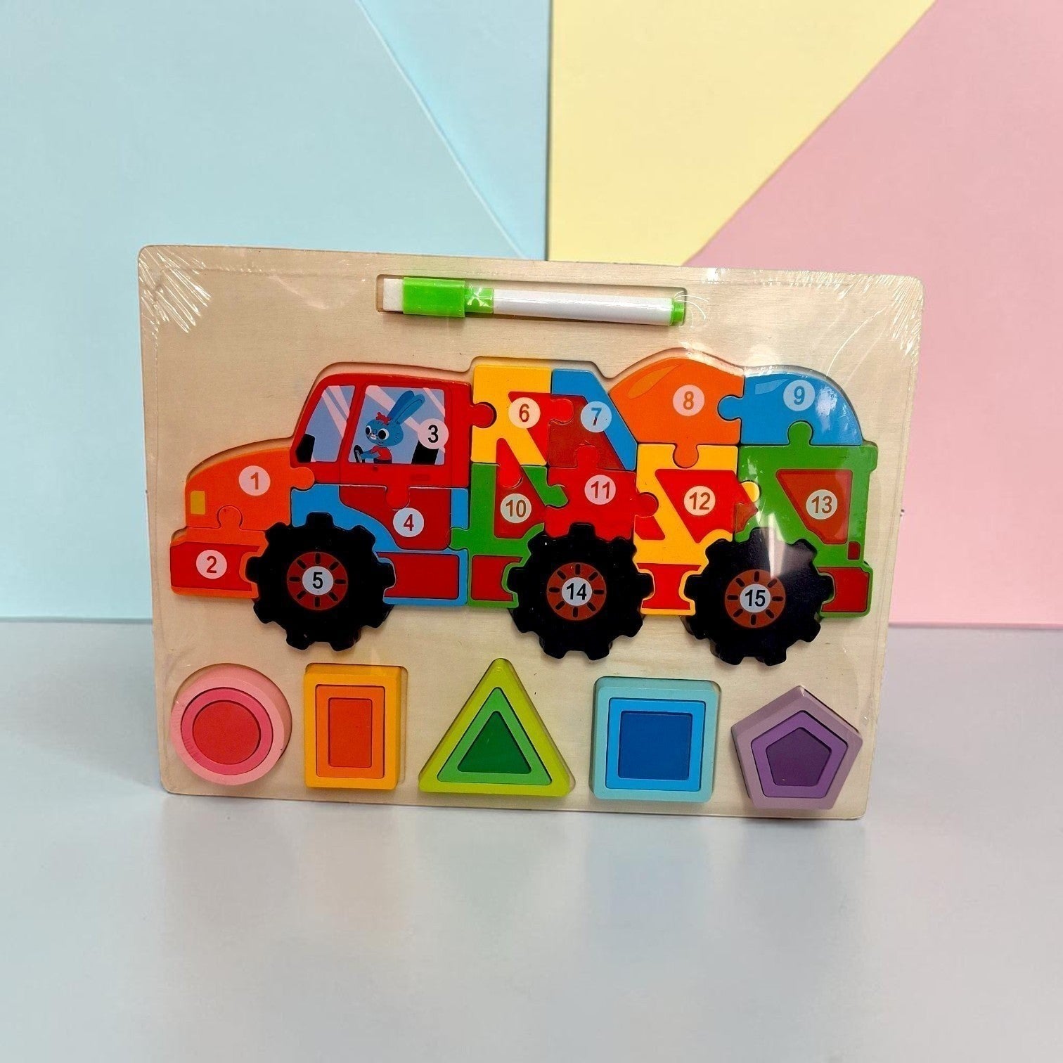 Tiny Tokens wooden truck puzzle with numbered pieces 1-15 and shape sorter. Includes erasable marker.